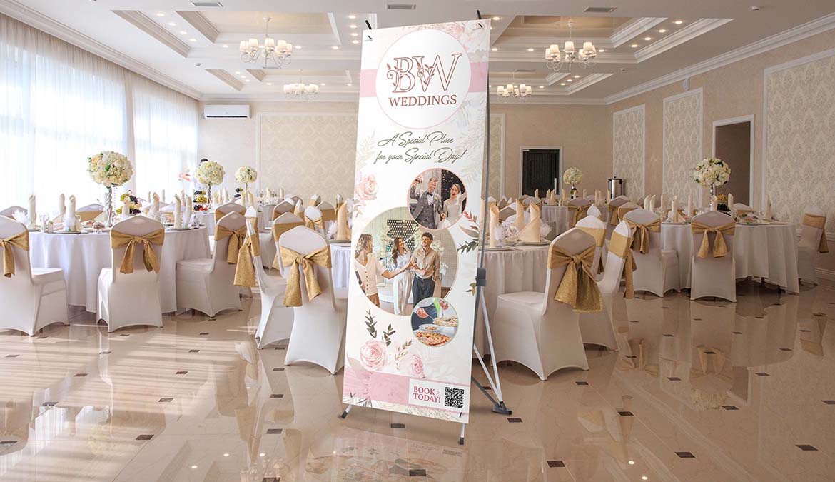 x banner stand displayed at indoor wedding venue