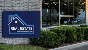 real estate yard sign in front of business