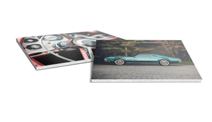 two ultra board classic car prints of classical cars laying flat on white background