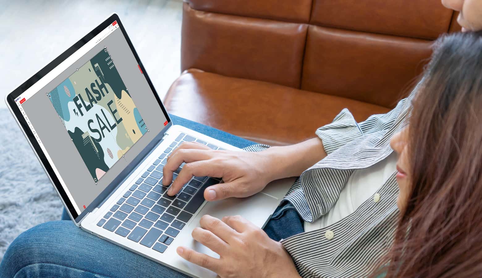 man and woman designing banners on a laptop