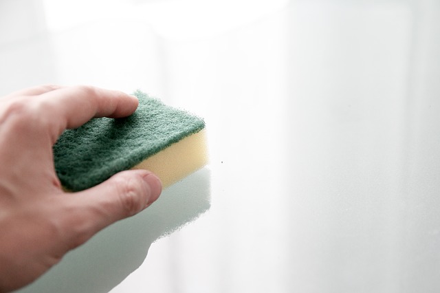 sponge cleaning the walls surface